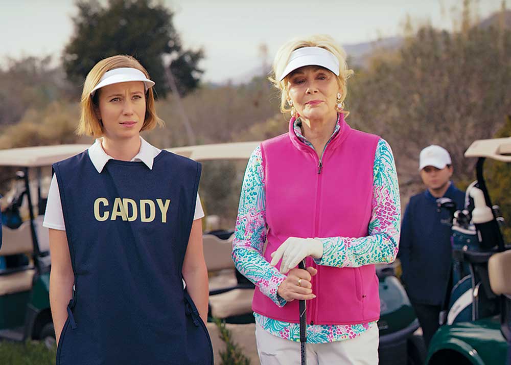 Hacks on Crave. Pictured: Ava (Hannah Einbinder) and Deborah (Jean Smart) hit the links in season three of Hacks.