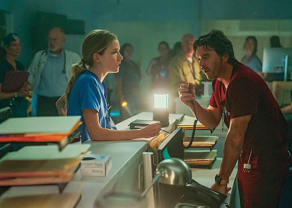 Pulse on Netflix. Pictured: New chief resident Danny Simms (Willa Fitzgerald) with charge nurse Luis Dominguez (Arturo Del Puerto).