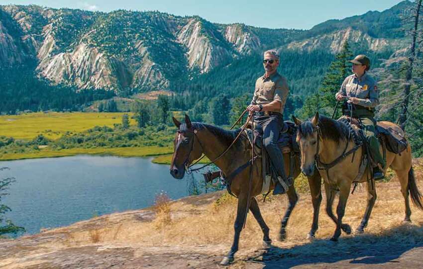 Untamed on Netflix. Pictured: Kyle Turner (Eric Bana) and Naya Vasquez (Lily Santiago) hit the trail to investigate a murder.