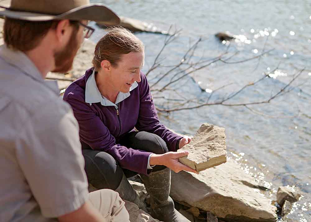 Walking With Dinosaurs on BBC Earth. Pictured: Alberta paleontologist Emily Bamforth examining a leaf fossil at a dig.