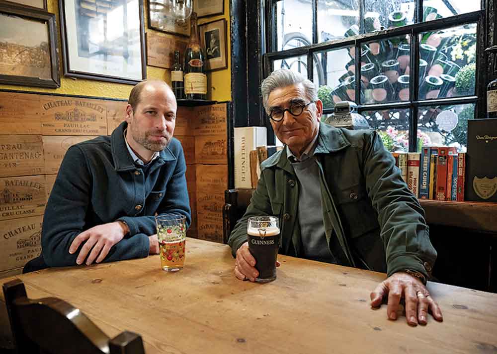 The Reluctant Traveler on Apple TV. Pictured: Eugene shares a hearty pint with Prince William in London.