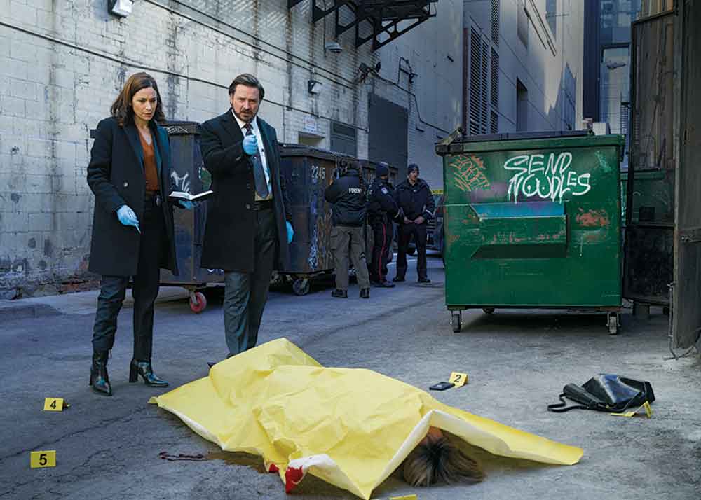 Law & Order Toronto: Criminal Intent on Citytv. Pictured: Detective Sergeant Henry Graff (Aden Young) and Detective Sergeant Frankie Bateman (Kathleen Munroe) unravel distinctly Canadian crimes on the streets of Toronto.