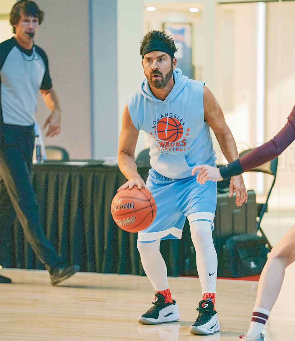 Running Point on Netflix. Pictured: Fresh out of rehab, Cam (Justin Theroux) has concocted a scheme to oust his sister from her leadership position and take over — but things don’t unfold as he’d planned.