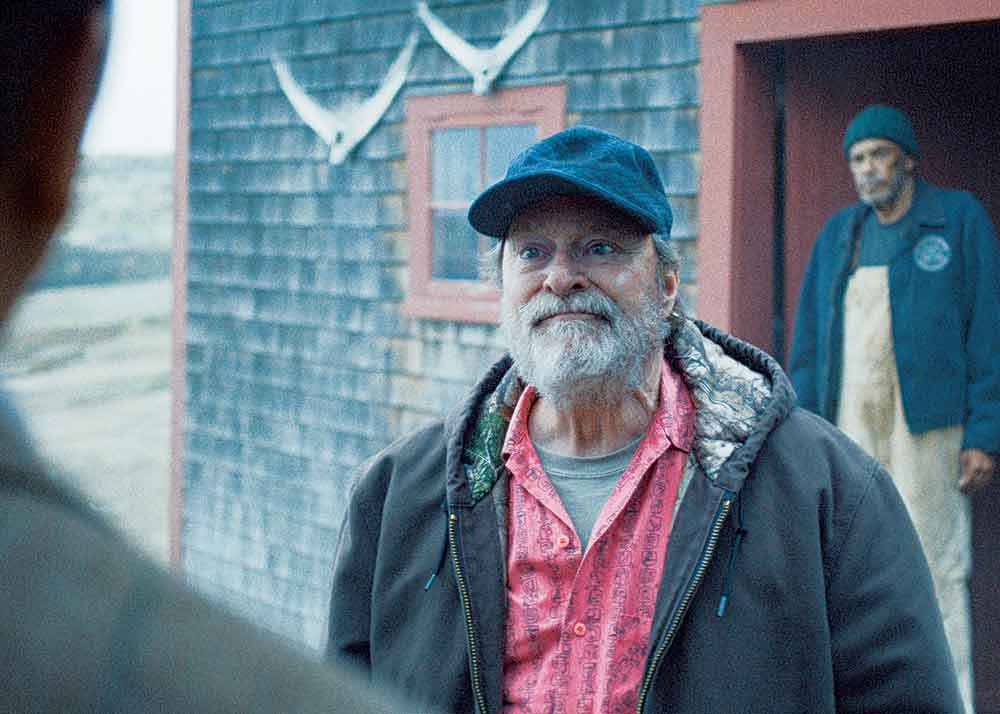 Widow’s Bay on Apple TV. Pictured: Stephen Root is Wyck, a local sea captain whose knowledge of Widow’s Bay runs deep.