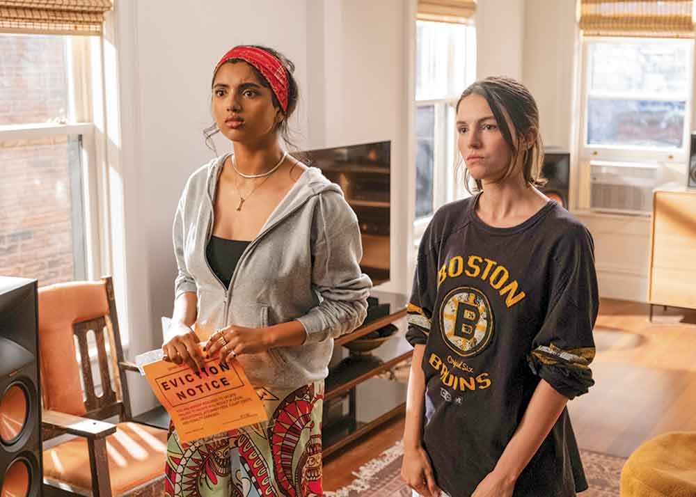 Not Suitable for Work on Disney+. Pictured: Roomies Abby (Avantika Vandanapu) and AJ (Ella Hunt) must smooth things over with their building’s super when they receive an eviction notice.